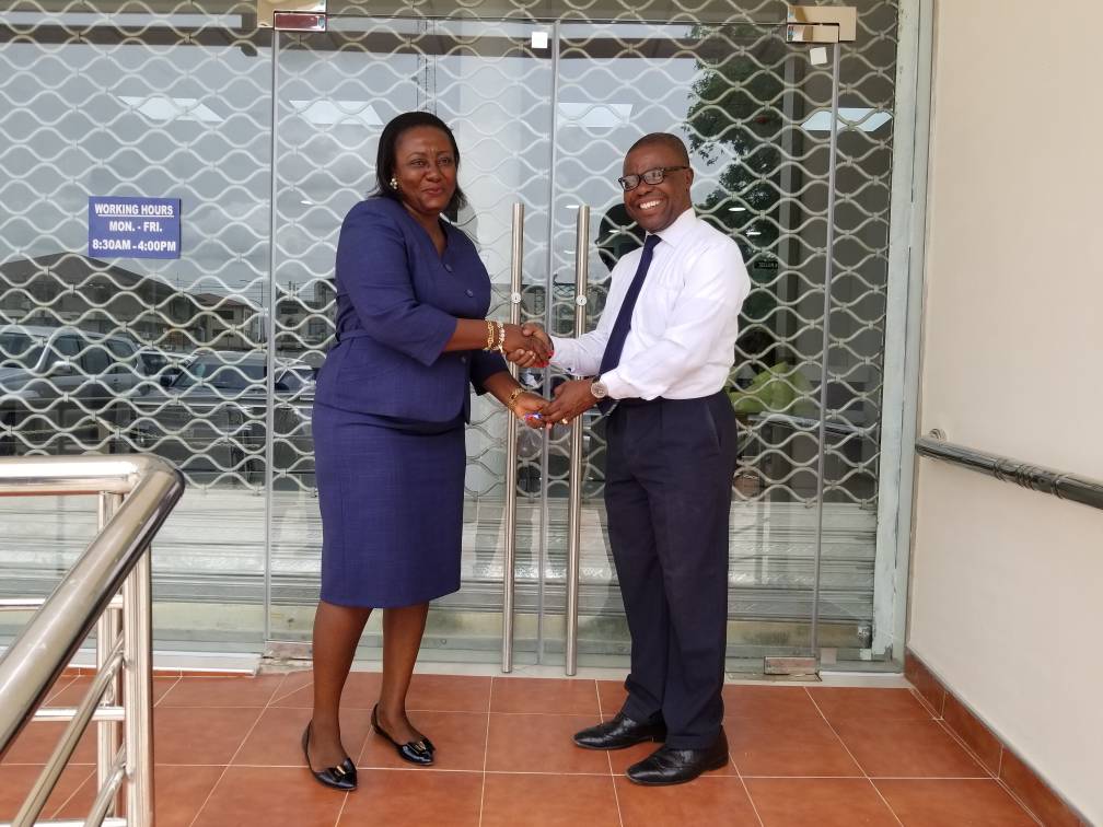 THE BOARD CHAIRMAN DR CHARLES ANANE HANDING OVER THE OFFICE KEYS TO THE MANAGERESS MAD CHRISTIANA B ATAKORA