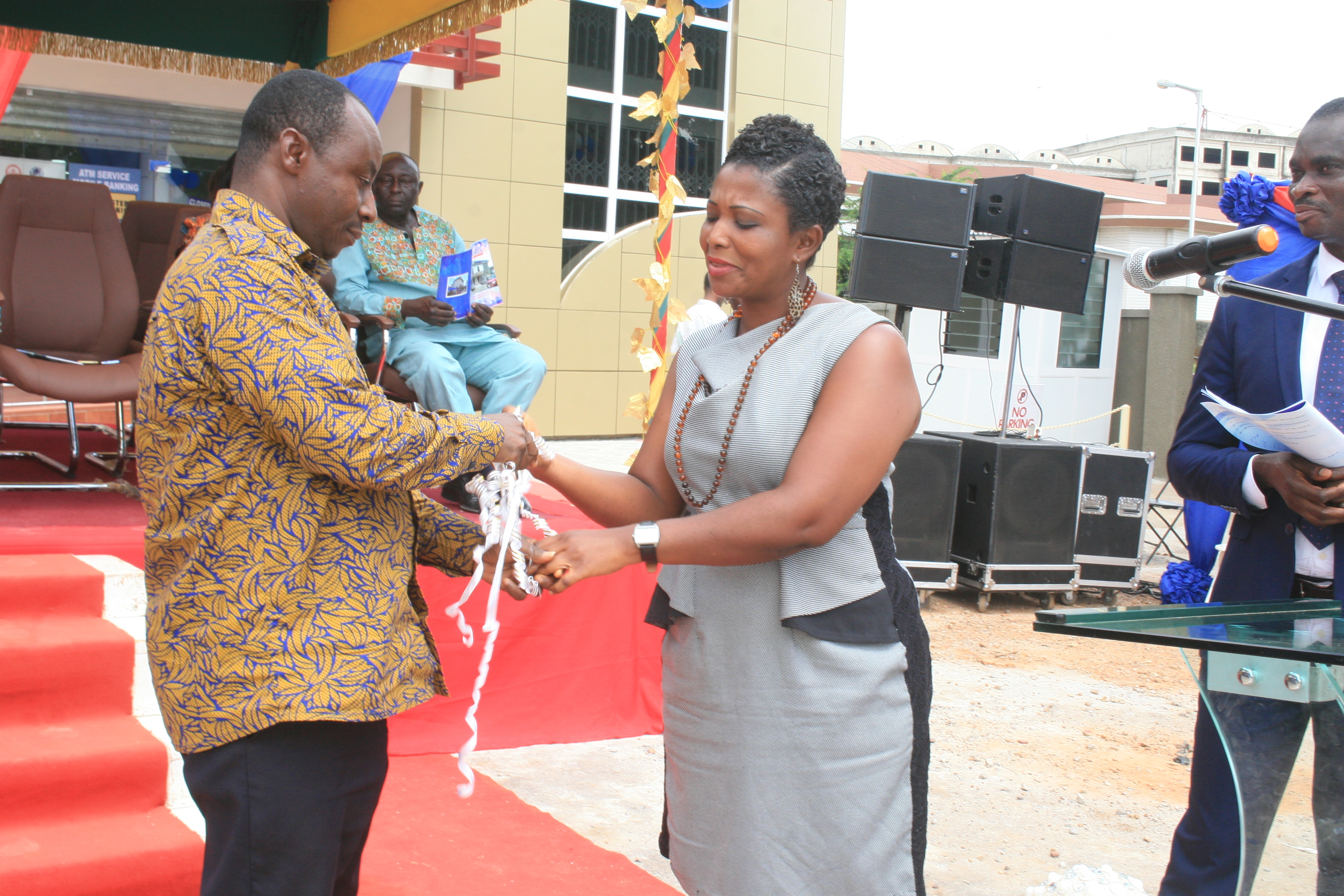 THE CONSULTANT MAD. ROSEMARY DWAMEN HANDING OVER THE OFFICE KEYS TO THE ESTATE MANAGER MR FREDERICK OPPONG 
